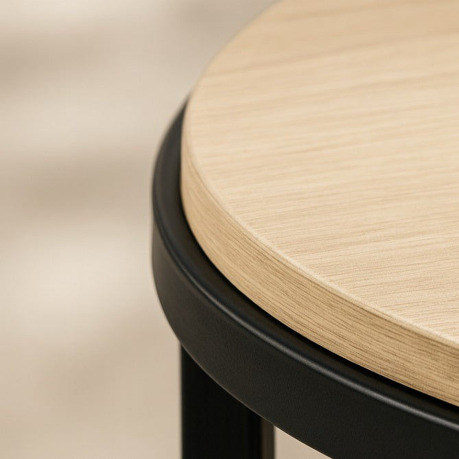 Détail du plateau en bois d’une table basse ronde relevable, finition élégante et structure métal noire.