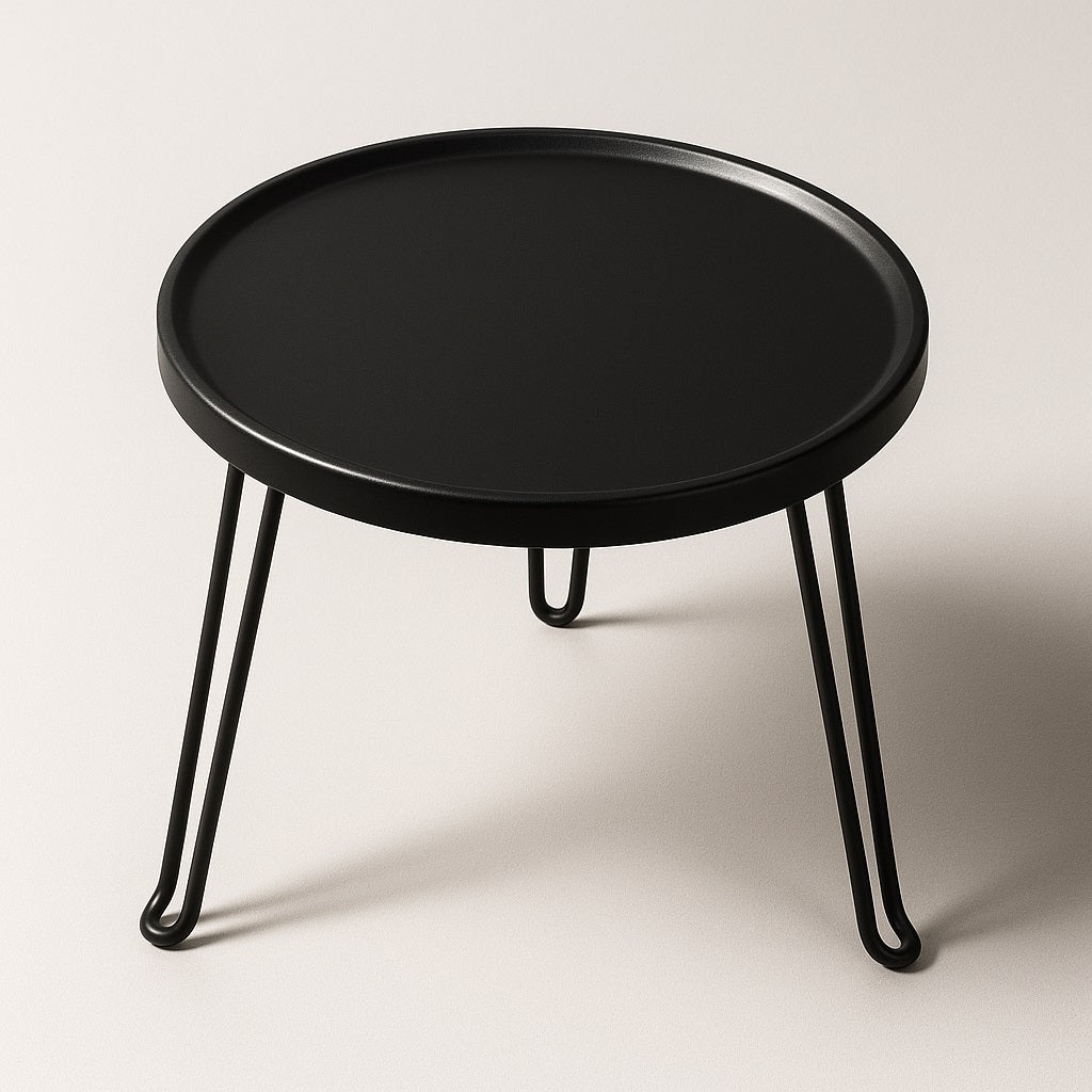 Table basse ronde noire en métal, vue en angle, style industriel et épuré pour décoration moderne.