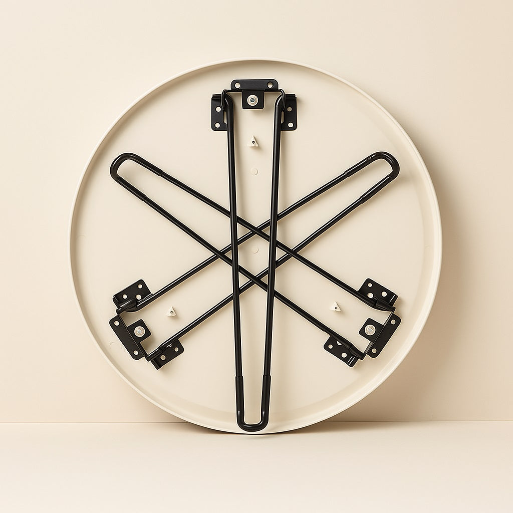 Structure pliable de la table basse ronde blanche Arcus, pieds en métal noir faciles à ranger.