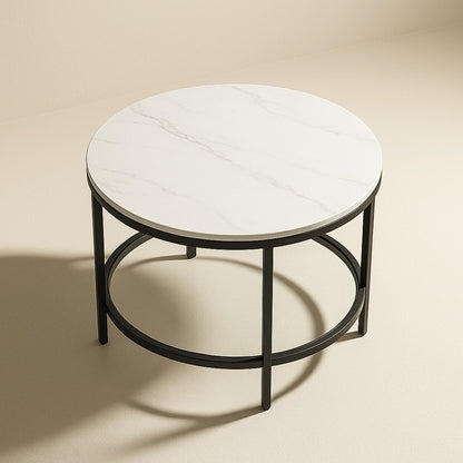 Table basse marbrée ronde avec pieds noirs et plateau blanc brillant, style moderne et épuré.
