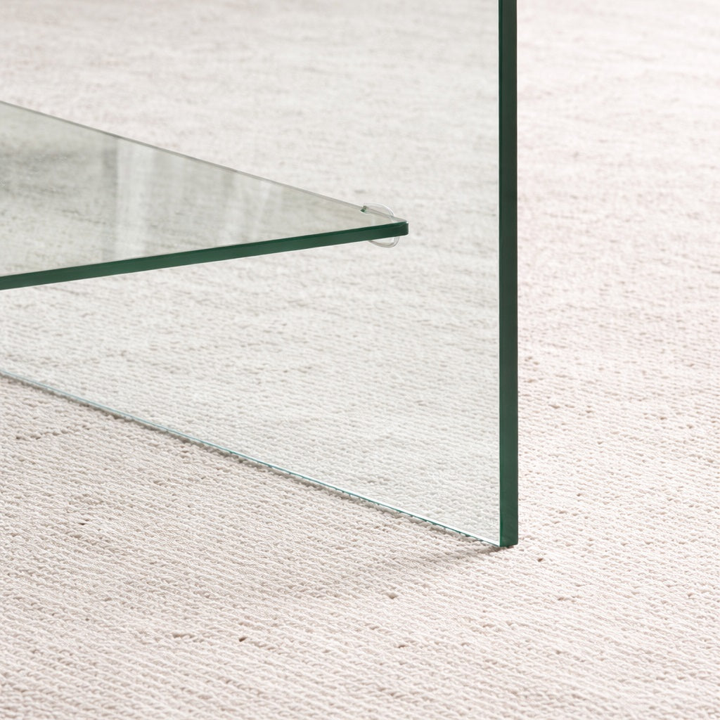 Détail de la table basse en verre design avec plateau transparent et finitions soignées, rendu haut de gamme