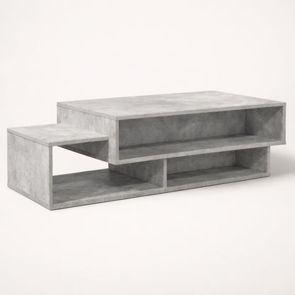 Table basse salon gris béton au design structuré, avec niches de rangement pour un style moderne.