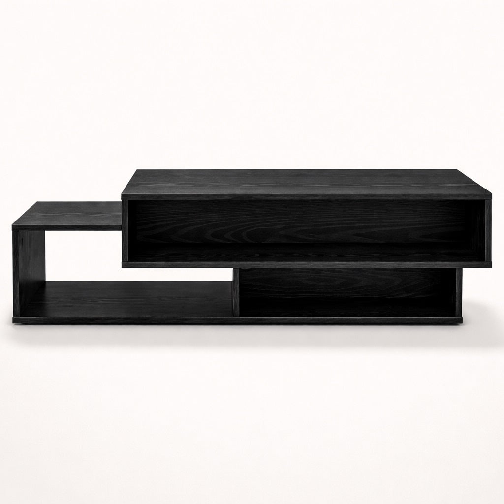 Table basse salon noire avec volumes graphiques et rangements intégrés, vue frontale sur fond clair.