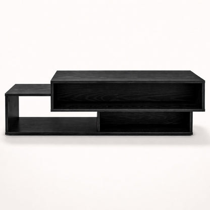 Table basse salon noire avec volumes graphiques et rangements intégrés, vue frontale sur fond clair.