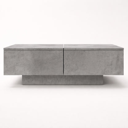 Table basse salon grise vue de face, lignes sobres et structure moderne avec rangement intégré.