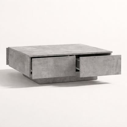 Table basse salon grise avec tiroirs coulissants, finition minérale et design contemporain.